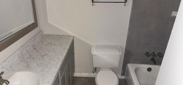 bathroom with a bathing tub, vanity, toilet, and tile patterned flooring