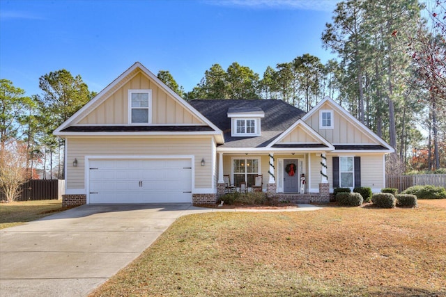 craftsman-style home with a garage, a porch, and a front yard