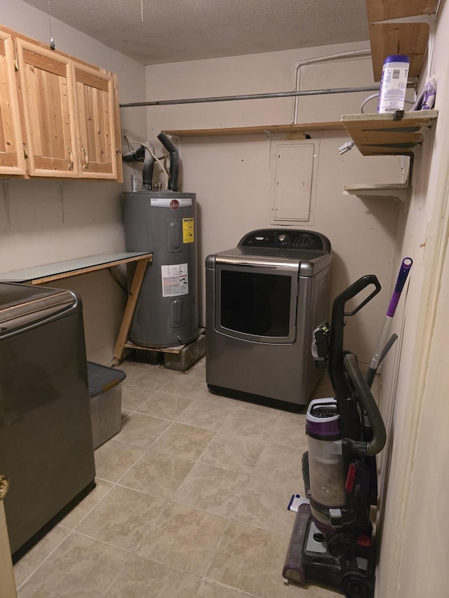 interior space featuring cabinet space, electric water heater, a textured ceiling, washer / dryer, and electric panel