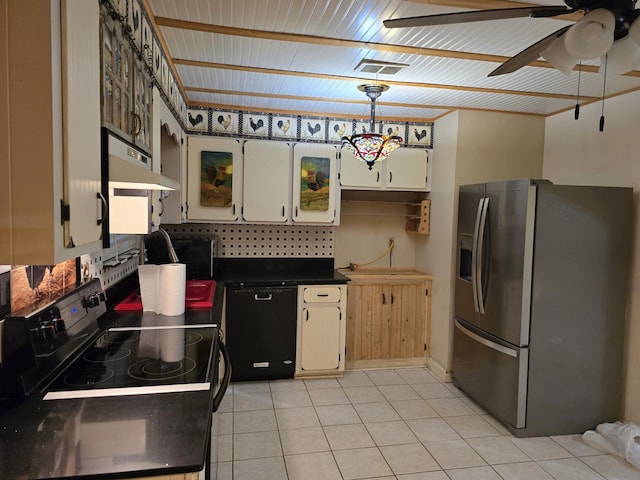 kitchen featuring dark countertops, visible vents, light tile patterned flooring, under cabinet range hood, and black appliances