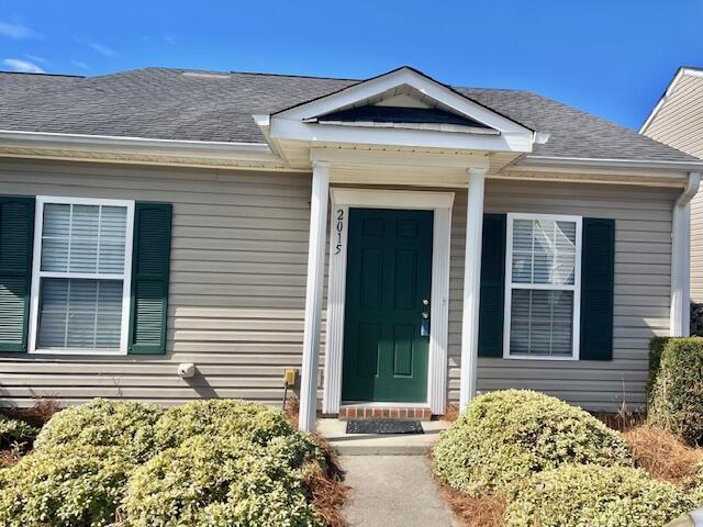 property entrance with roof with shingles