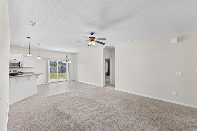 unfurnished living room with baseboards, visible vents, light colored carpet, a textured ceiling, and ceiling fan with notable chandelier