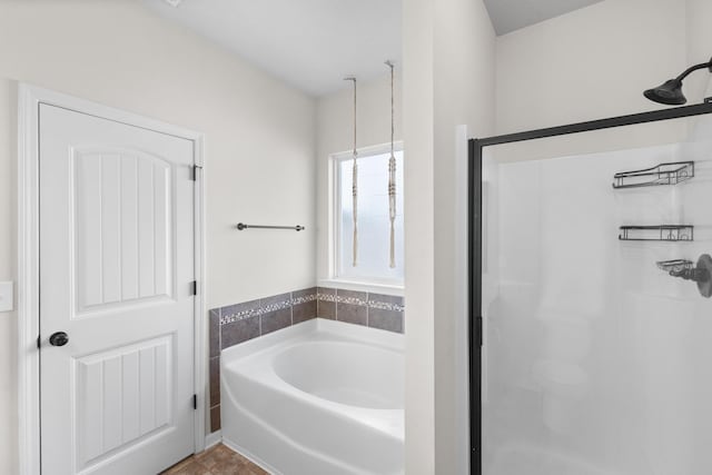 full bathroom featuring a garden tub and a shower stall