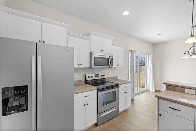 kitchen featuring pendant lighting, stainless steel appliances, recessed lighting, and white cabinets