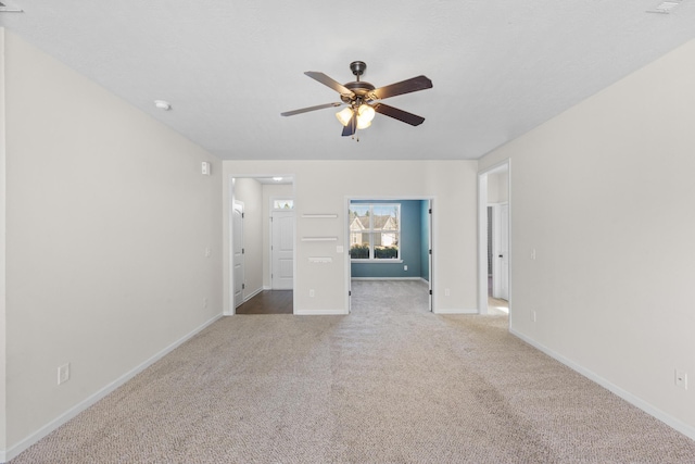 interior space with ceiling fan and baseboards