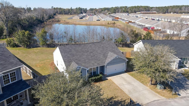 drone / aerial view featuring a residential view and a water view