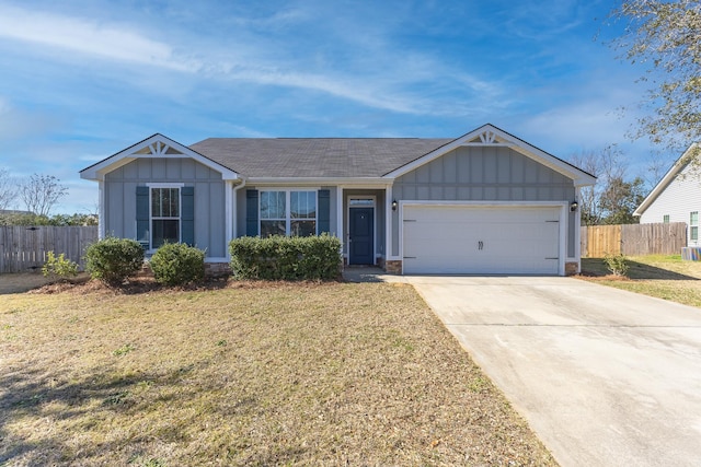 single story home featuring a garage, fence, driveway, a front lawn, and board and batten siding