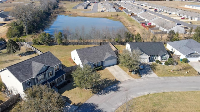 drone / aerial view featuring a water view and a residential view