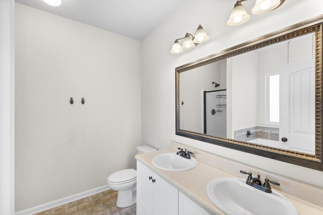 bathroom featuring baseboards, a sink, toilet, and walk in shower