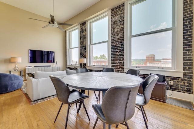 936 Broad St, Augusta, GA 30901 - dining space with plenty of natural light, light wood finished floors, ceiling fan, baseboards, and brick wall
