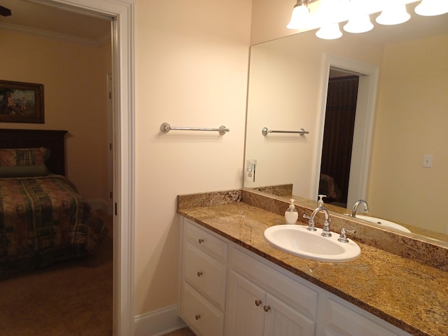 bathroom featuring connected bathroom, vanity, and ornamental molding