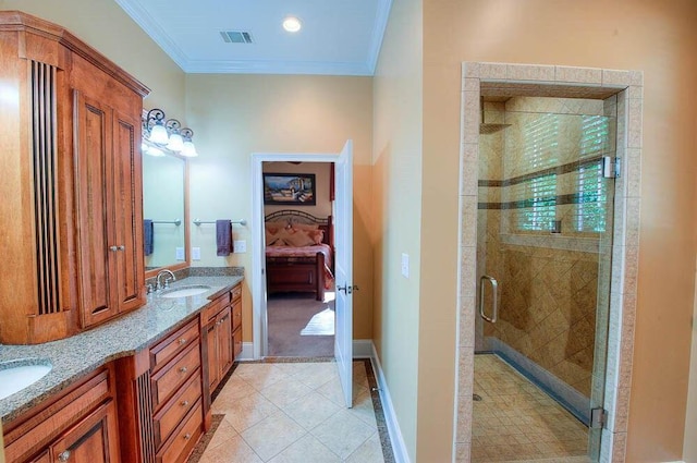 bathroom featuring a sink, a stall shower, tile patterned flooring, and ornamental molding