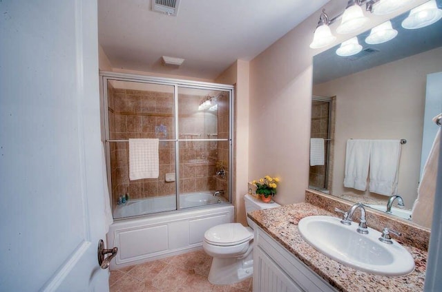 full bathroom with tile patterned floors, visible vents, toilet, shower / bath combination with glass door, and vanity