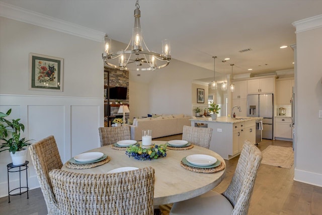 118 Bereau Dr, Mccormick, SC 29835 - dining space with wood finished floors, a notable chandelier, ornamental molding, and wainscoting