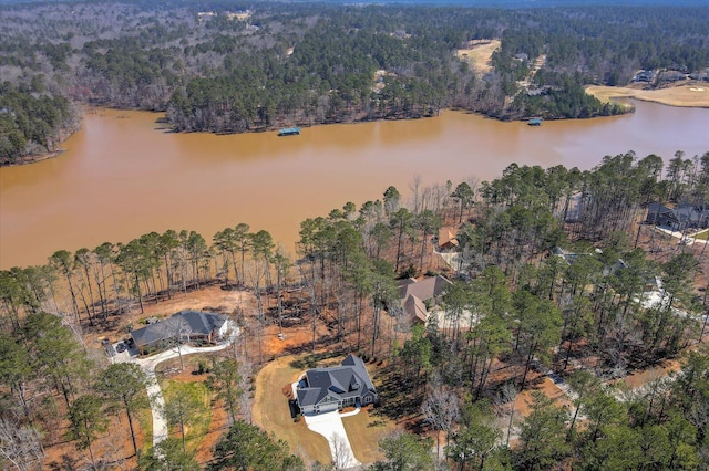 aerial view featuring a wooded view and a water view