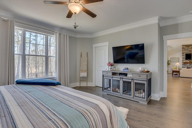 118 Bereau Dr, Mccormick, SC 29835 - bedroom with a fireplace, crown molding, baseboards, and wood finished floors