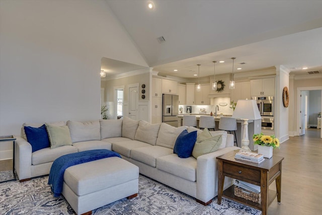 118 Bereau Dr, Mccormick, SC 29835 - living room featuring visible vents, high vaulted ceiling, recessed lighting, light wood-style floors, and crown molding