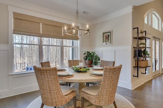 118 Bereau Dr, Mccormick, SC 29835 - dining room with visible vents, a notable chandelier, dark wood finished floors, crown molding, and a decorative wall