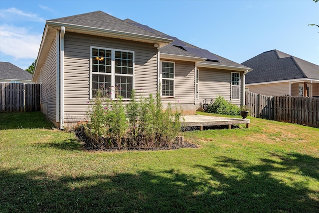 570 Lory Ln, Grovetown, GA 30813 - rear view of property featuring solar panels, a wooden deck, and a fenced backyard