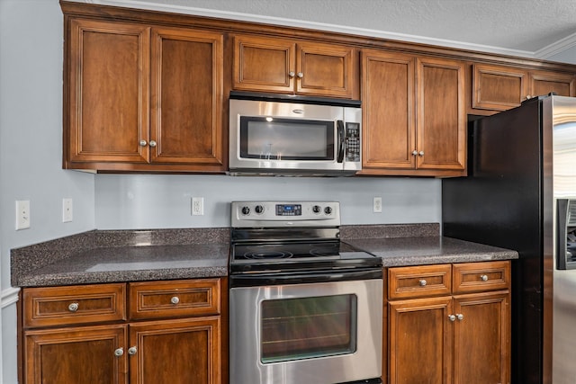 570 Lory Ln, Grovetown, GA 30813 - kitchen with stainless steel appliances, dark countertops, and brown cabinets