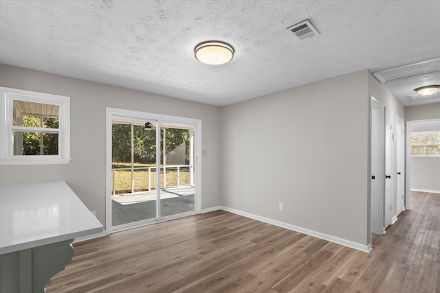 interior space with wood-type flooring and a textured ceiling