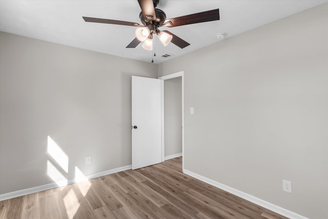 spare room with ceiling fan and light hardwood / wood-style flooring