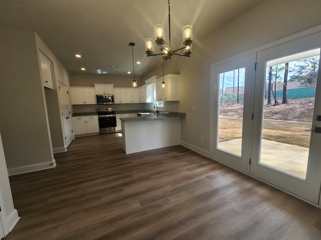 kitchen with stainless steel appliances, dark wood-type flooring, white cabinetry, and baseboards