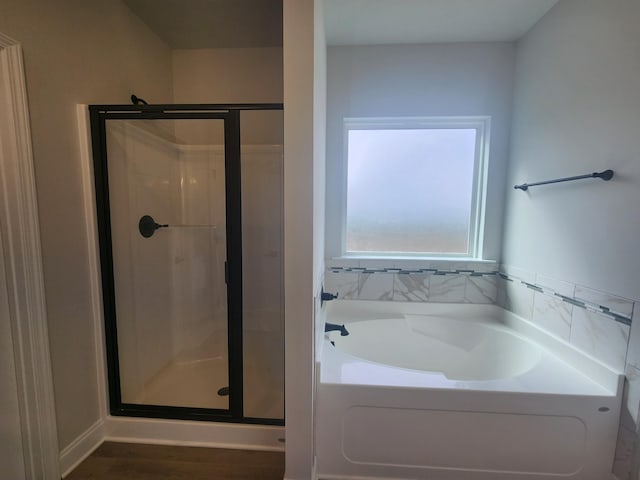 full bath featuring a garden tub and a shower stall