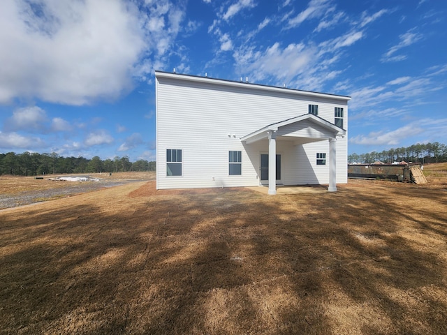 rear view of house with a lawn