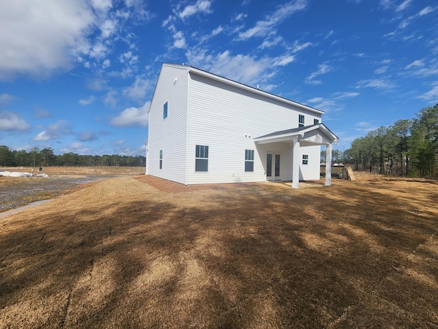 rear view of house featuring a yard