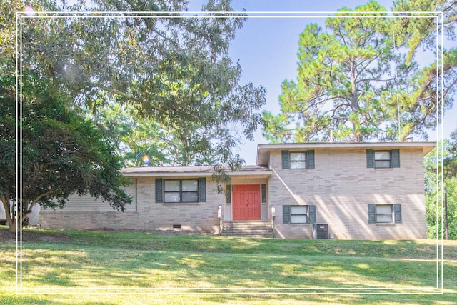 tri-level home with central AC and a front lawn