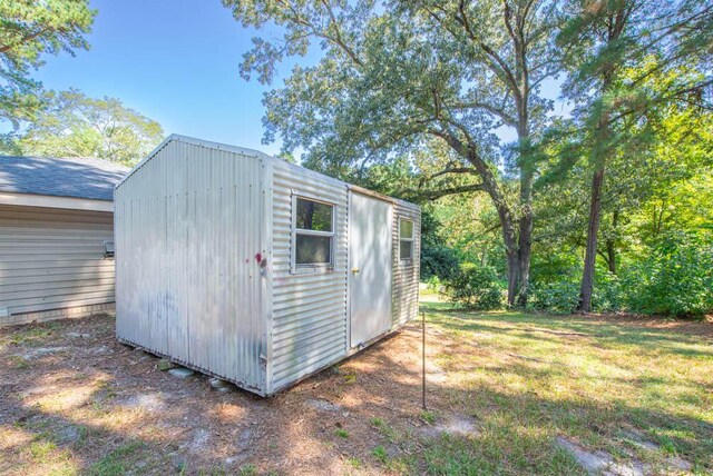 view of outbuilding with a lawn