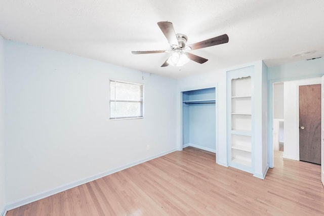 unfurnished bedroom with a textured ceiling, light wood-type flooring, and ceiling fan