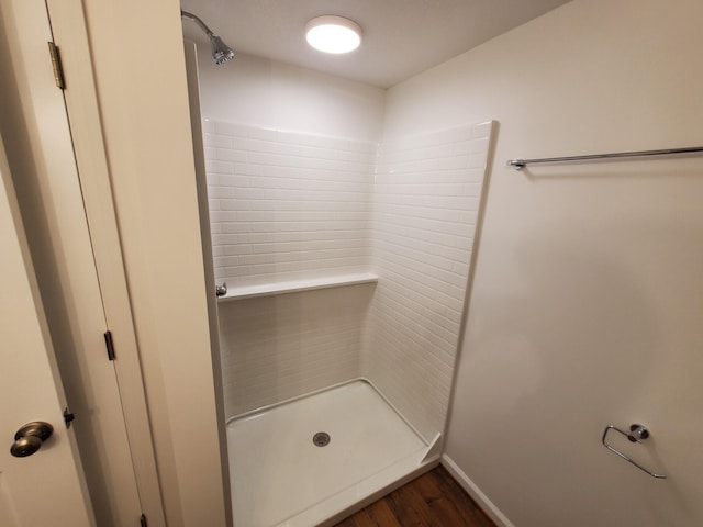 bathroom featuring hardwood / wood-style floors and walk in shower