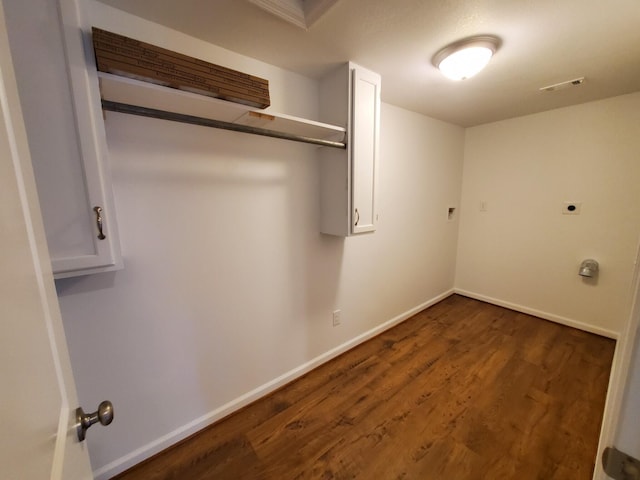 laundry room featuring hookup for an electric dryer and dark wood-type flooring