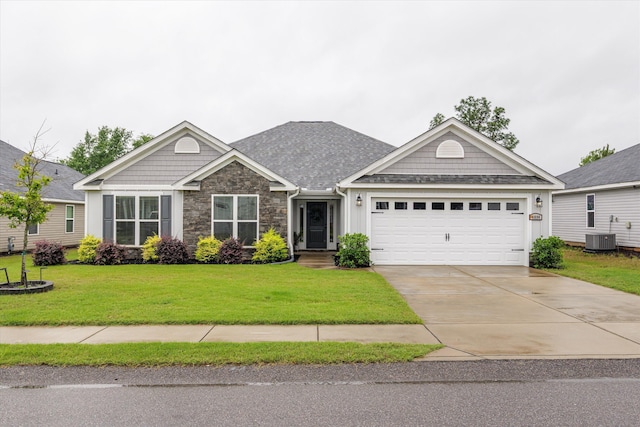 4894 Fairmont Dr, Graniteville, SC 29829 - view of front of home with stone siding, an attached garage, concrete driveway, central air condition unit, and a front lawn