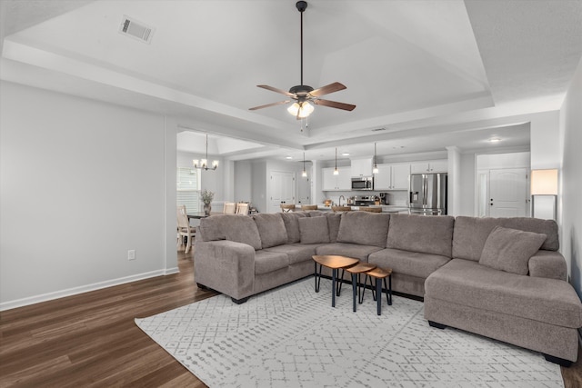 4894 Fairmont Dr, Graniteville, SC 29829 - living area featuring a raised ceiling, wood finished floors, a ceiling fan, a chandelier, and baseboards