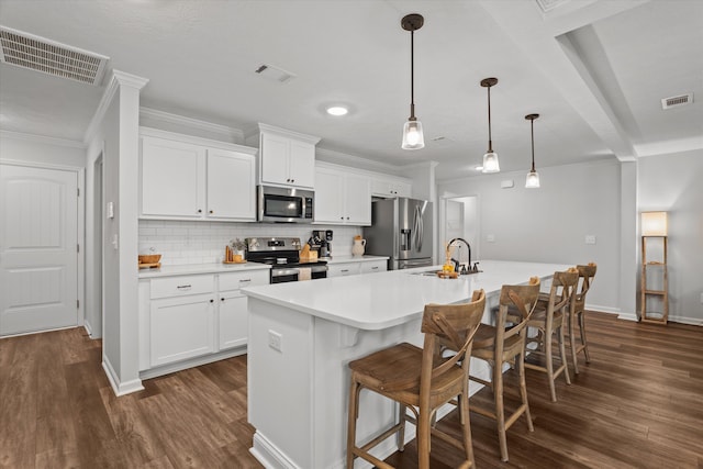 4894 Fairmont Dr, Graniteville, SC 29829 - kitchen featuring stainless steel appliances, a sink, dark wood-style flooring, an island with sink, and light countertops