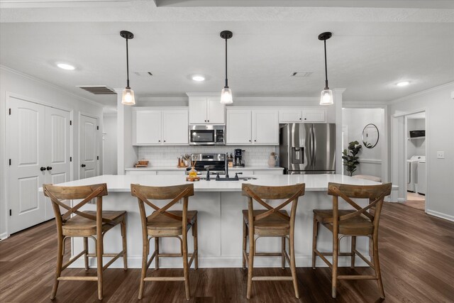 4894 Fairmont Dr, Graniteville, SC 29829 - kitchen with appliances with stainless steel finishes, a sink, crown molding, dark wood finished floors, and light countertops