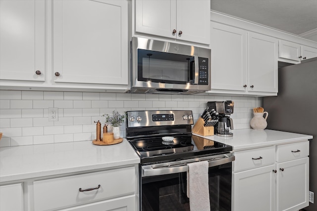 4894 Fairmont Dr, Graniteville, SC 29829 - kitchen featuring stainless steel appliances, light countertops, white cabinets, and decorative backsplash