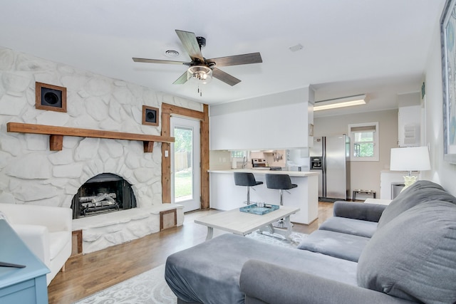 3202 Norris Ct, Augusta, GA 30907 - living area with light wood-style floors, healthy amount of natural light, a ceiling fan, and a fireplace