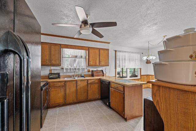 464 Rachel Dr, Evans, GA 30809 - kitchen featuring black appliances, brown cabinets, a peninsula, a textured ceiling, and wainscoting