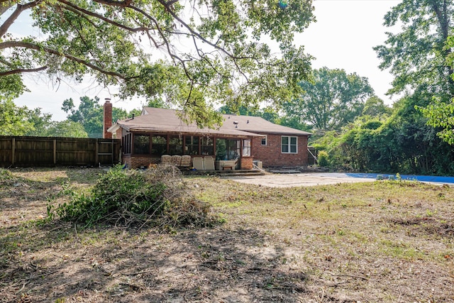 464 Rachel Dr, Evans, GA 30809 - back of property with a sunroom, brick siding, and a chimney