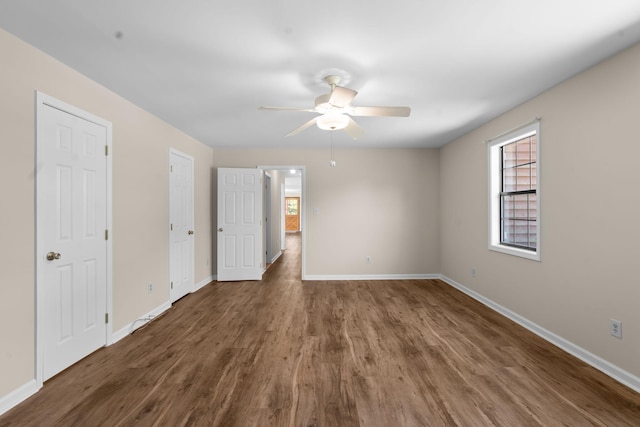 spare room featuring ceiling fan and dark hardwood / wood-style floors