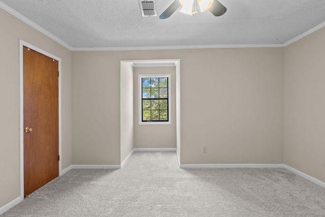 carpeted empty room featuring a textured ceiling, ceiling fan, and crown molding