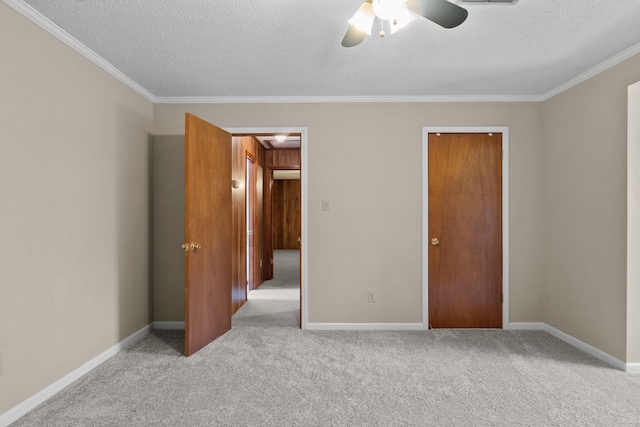 unfurnished bedroom with light carpet, a textured ceiling, ceiling fan, and ornamental molding