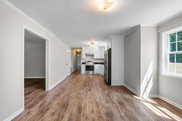 unfurnished living room featuring crown molding and light hardwood / wood-style floors