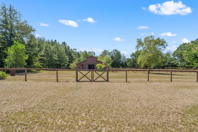 view of yard with a rural view and an outbuilding