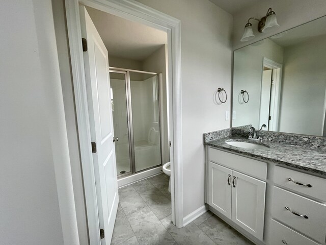 bathroom with vanity, toilet, and an enclosed shower