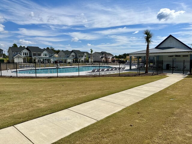 view of swimming pool featuring a lawn